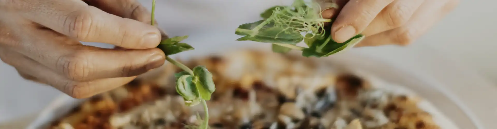 A leafy ingredient that will be mixed with the pizza.